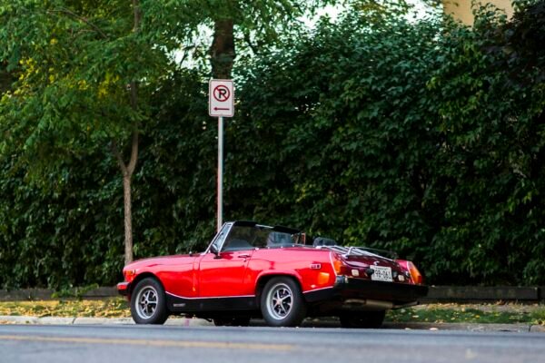 Red sports car parked on the roadside