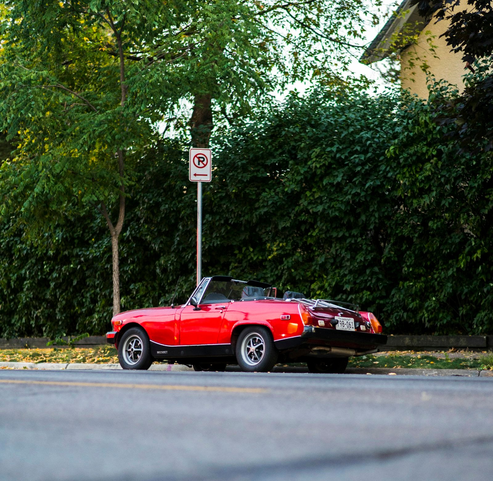 Red sports car parked on the roadside