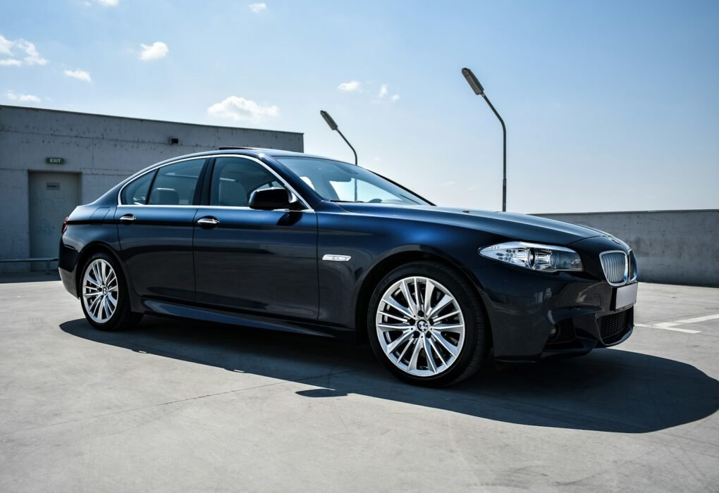 Black luxury sedan parked on a street