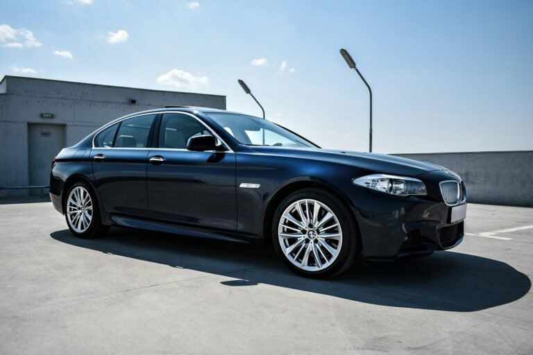 Black luxury sedan parked on a street