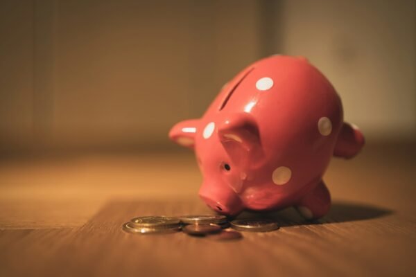 Piggy bank with coins on a table