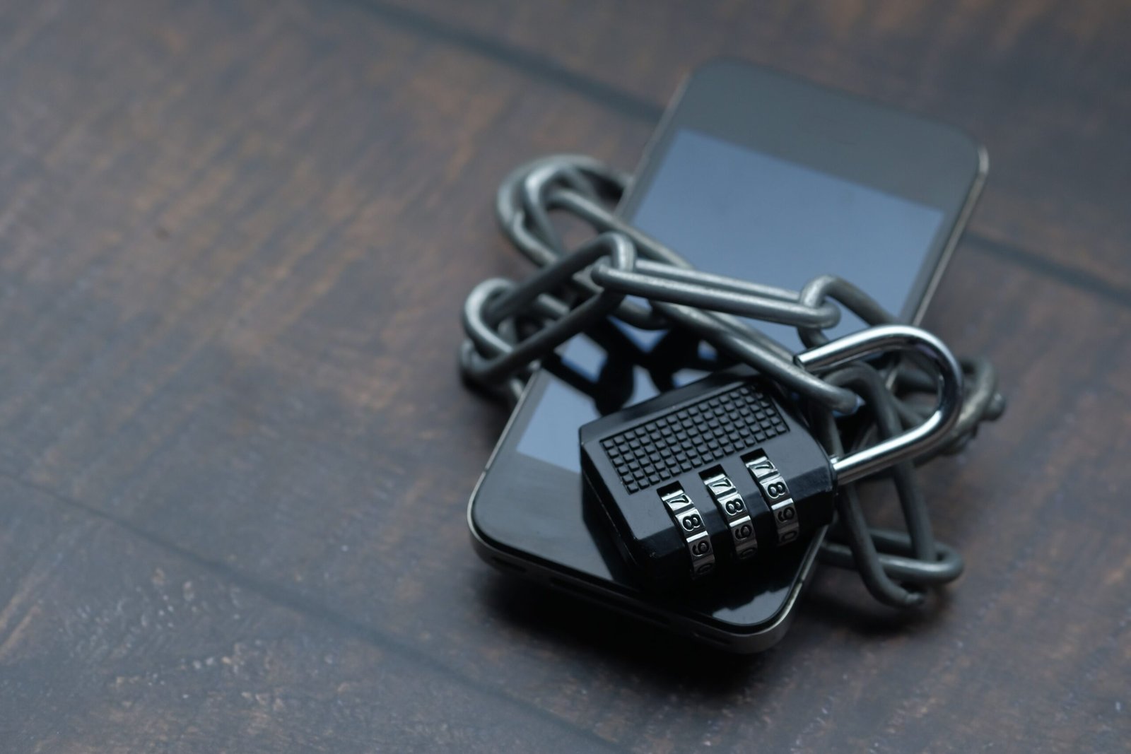 Smartphone secured with a padlock and chain, symbolizing digital protection against cyber threats